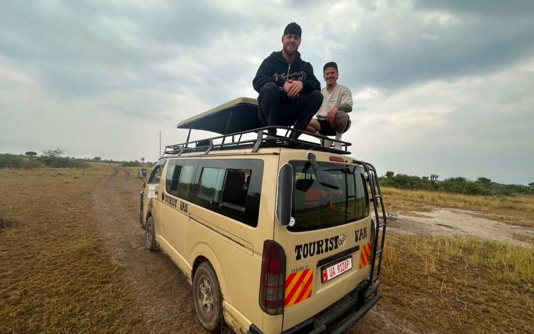 Two men on top of van