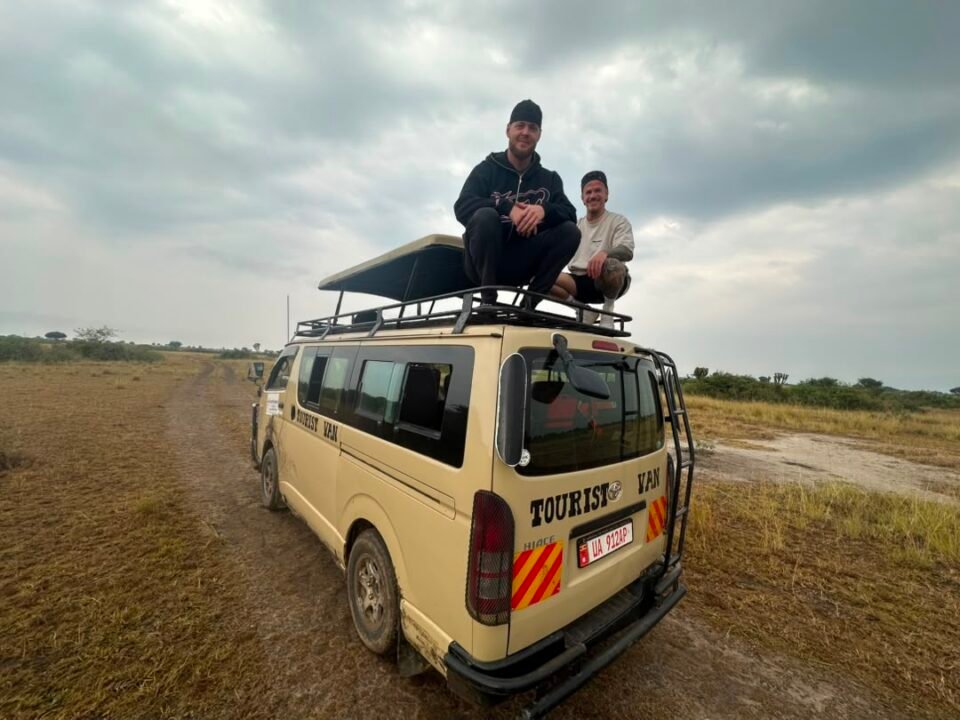 Two men on top of van